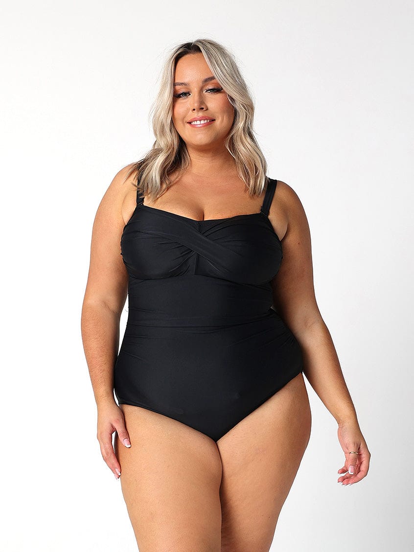 curvy model wearing black strapless one piece