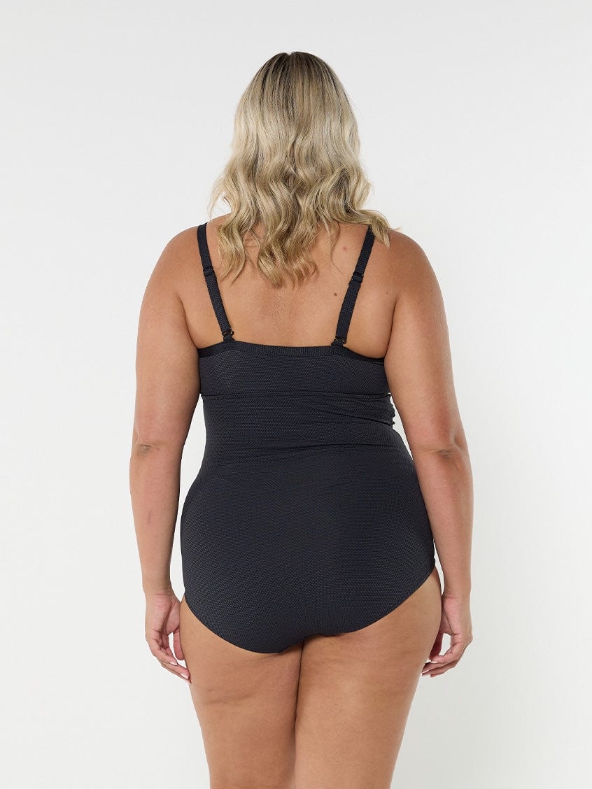 model showing back of black textured underwire one piece
