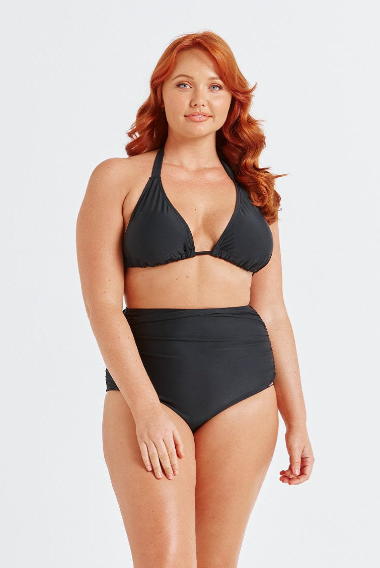 model wearing flattering black high waisted swim bottoms