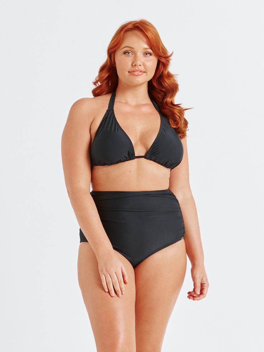 model wearing flattering black high waisted swim bottoms