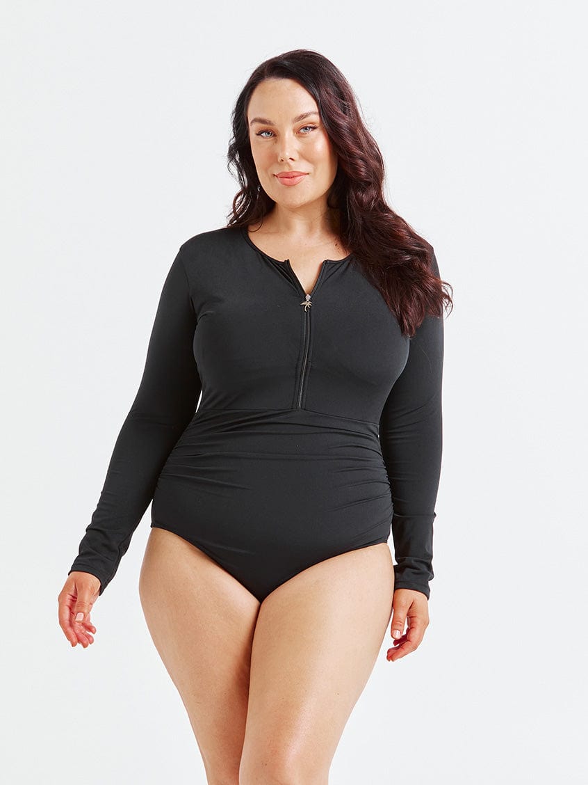 model wearing black long sleeve one piece with zip front