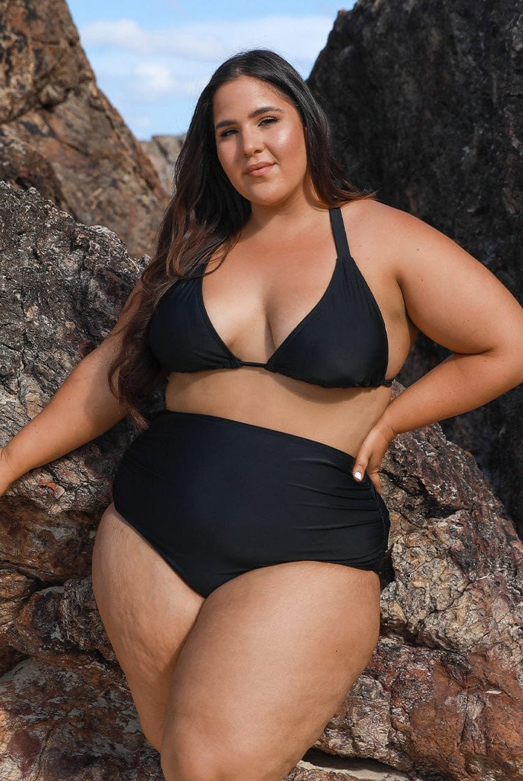 model wearing black high waisted ruched bikini bottom