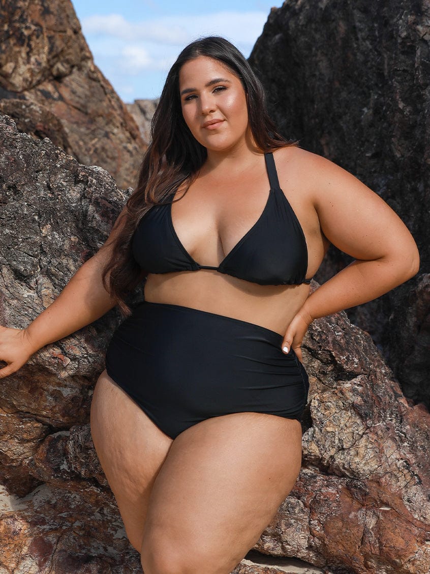 model wearing black high waisted ruched bikini bottom