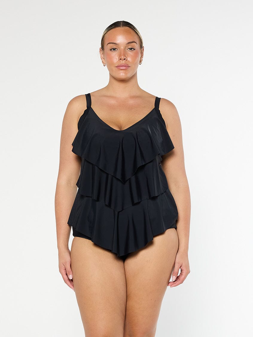 model wearing black three tier tankini