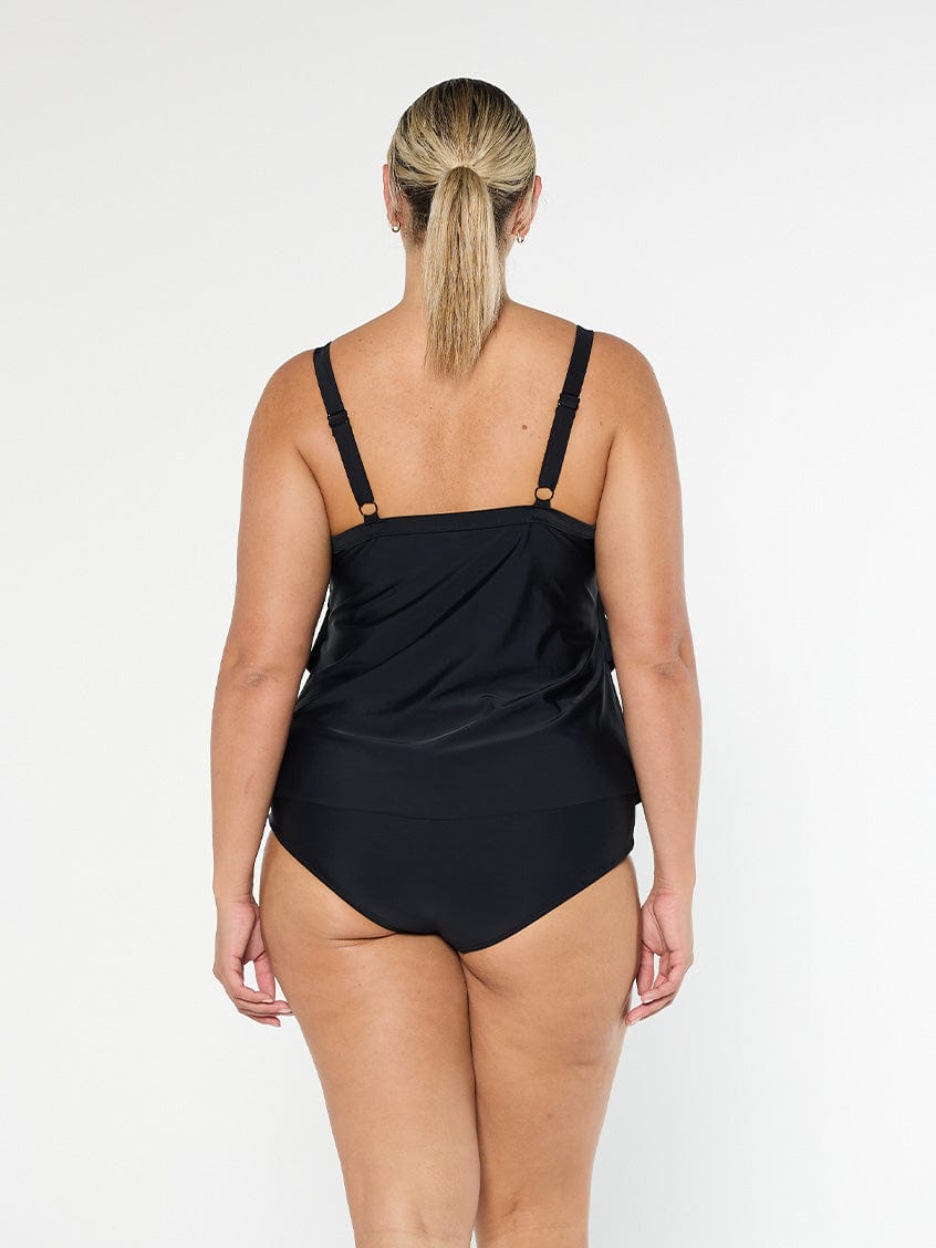 model wearing black three tier tankini top