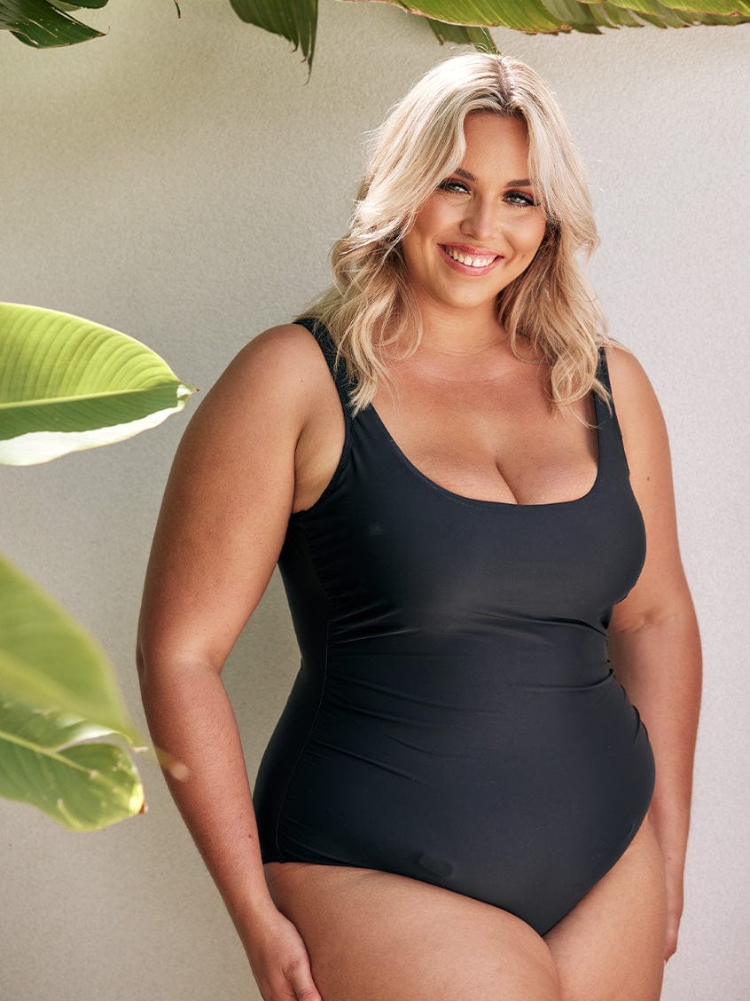 model wearing plain black ladies one piece