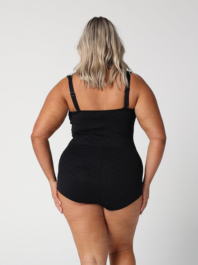 model showing back of black retro style one piece