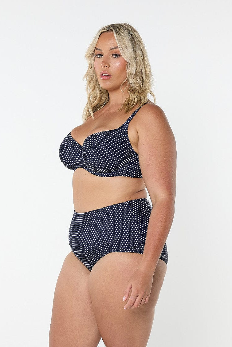 model showing side of navy polka dot bikini top