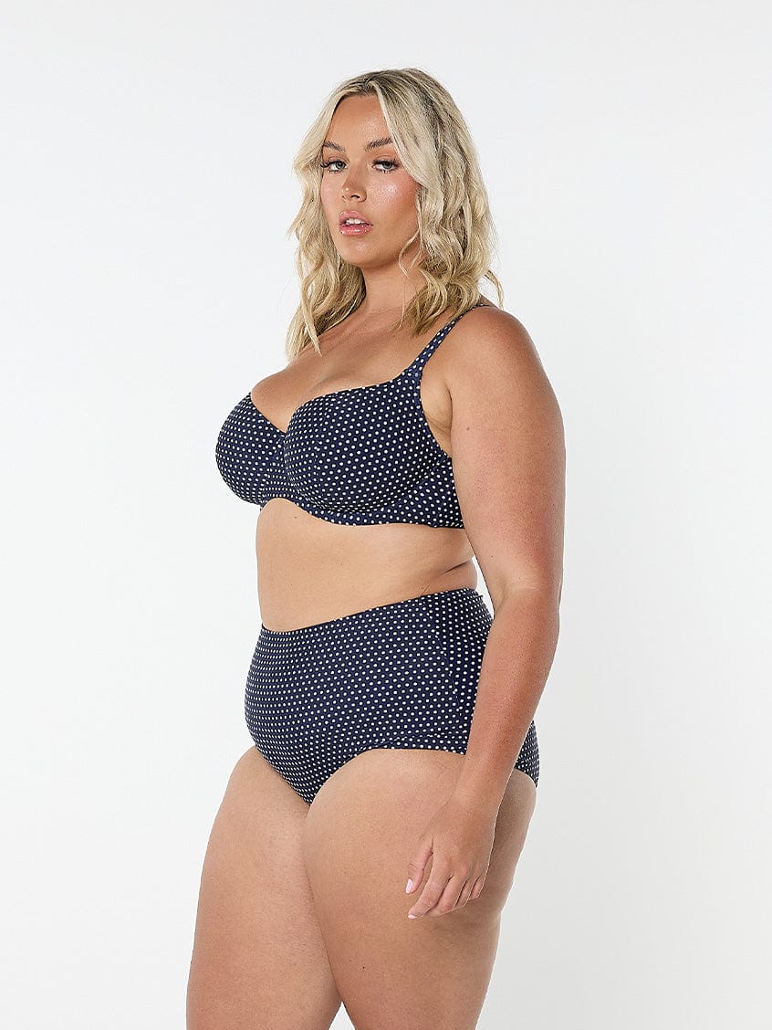 model showing side of navy and white dots swim pant