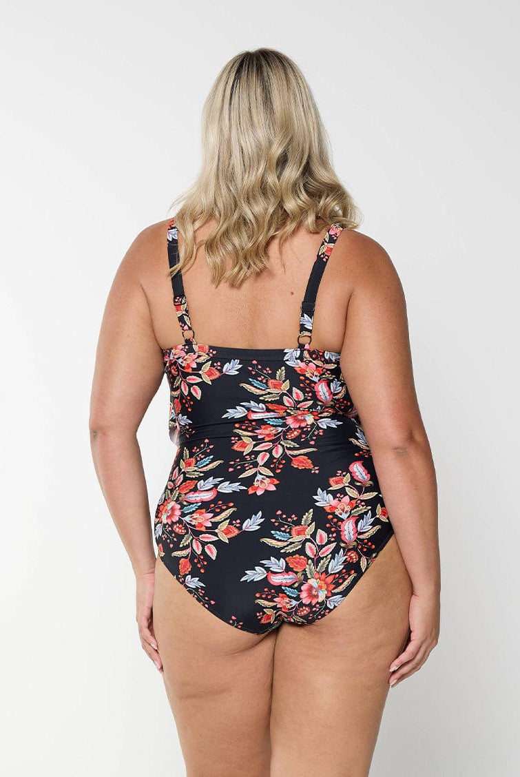 model showing back of black and red floral layered women's swimsuit