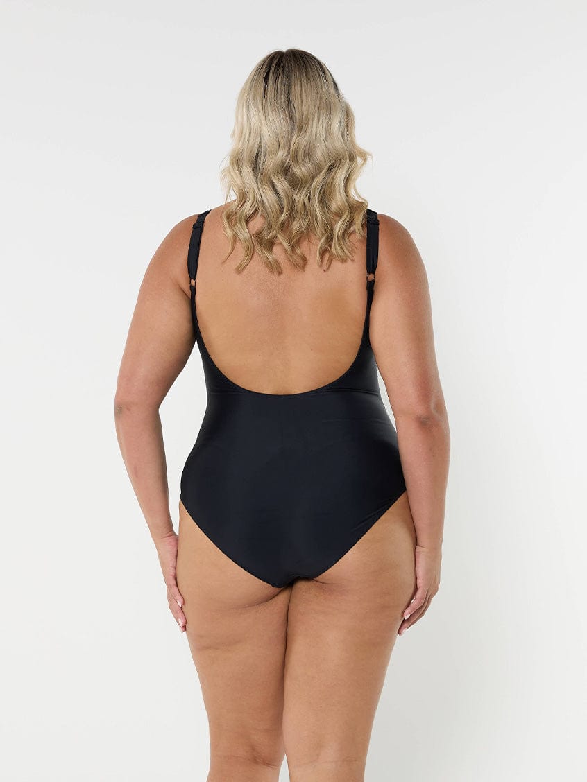 model showing low back of women's black one piece
