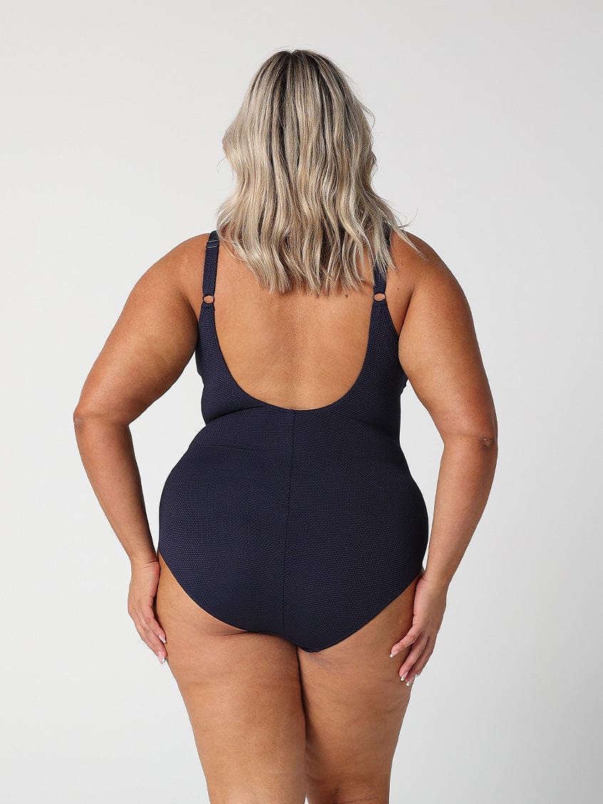 model show back of low back navy textured swimsuit