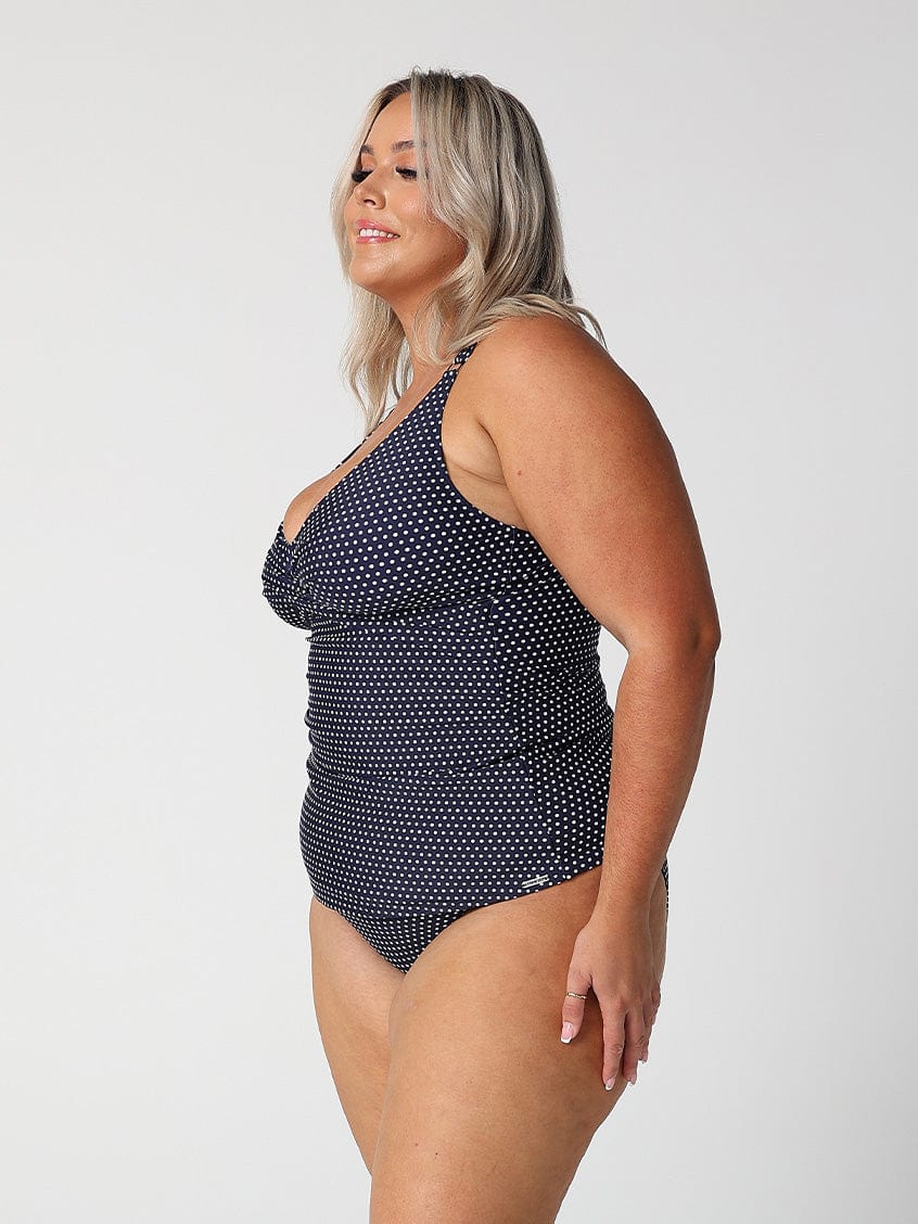 model showing side of navy dots cross front tankini top