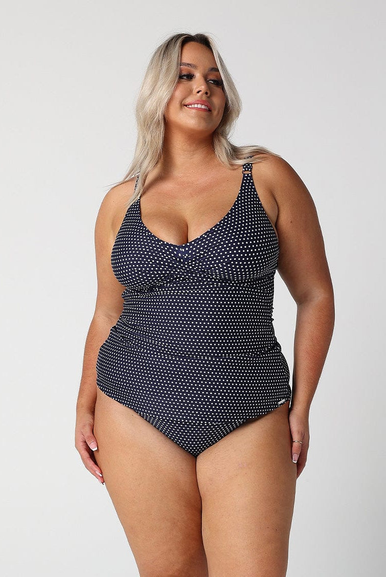 model wearing navy and white dots swing tankini
