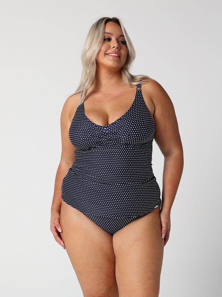 model wearing navy and white dots swing tankini