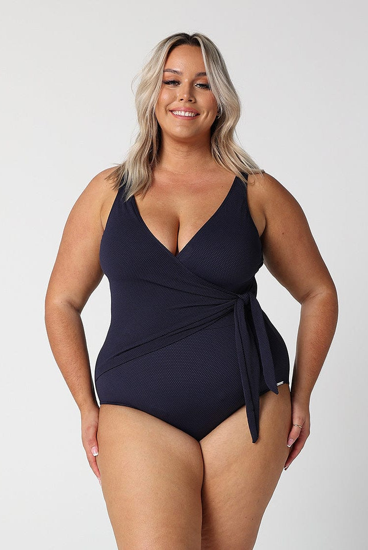 model wearing navy textured waist tie swimsuit