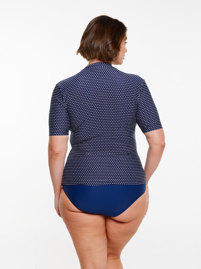 model wearing navy and white dots short sleeve rashie