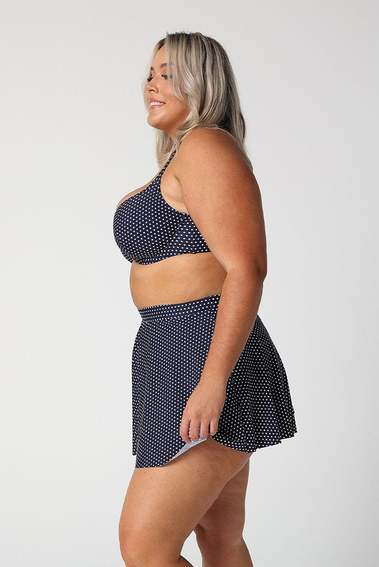 model showing side of navy and white dots skater skirt