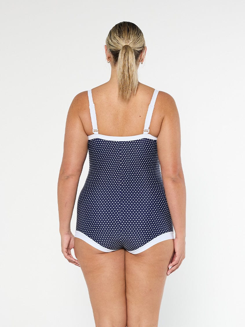 model showing back of navy dots boyleg one piece