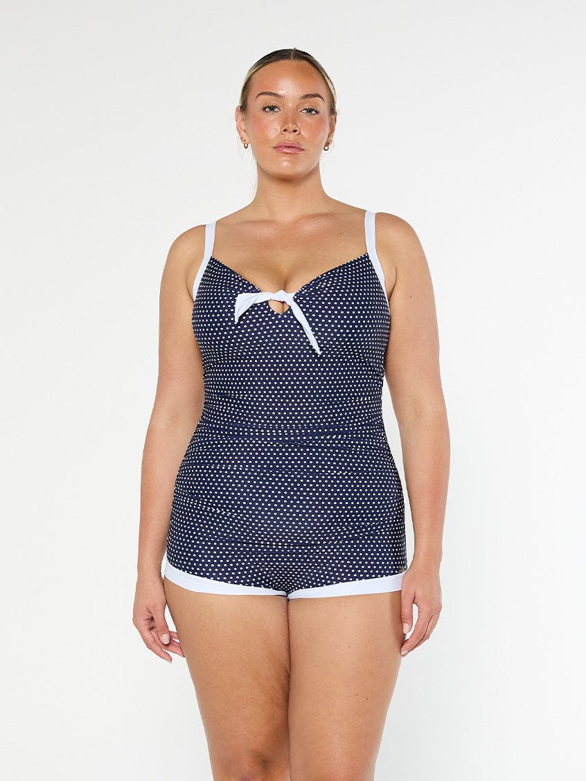 model wearing navy and white dots boyleg women's swimsuit