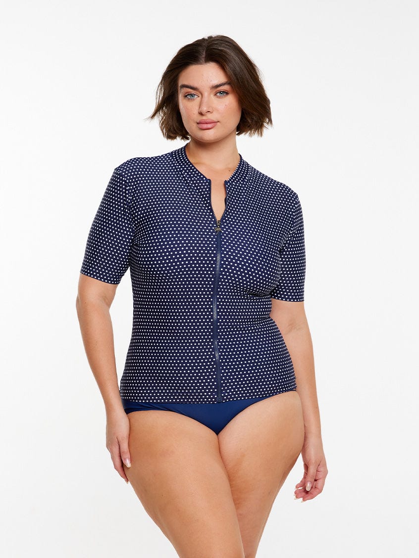 model wearing navy dots zip front rashie