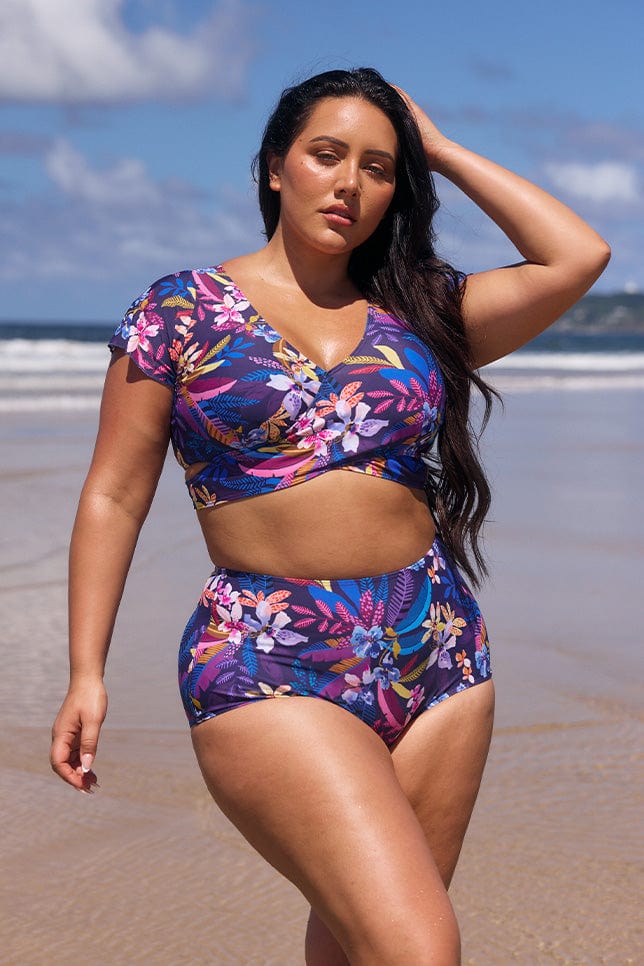 Front of model on beach wearing plus size high waisted swim pant
