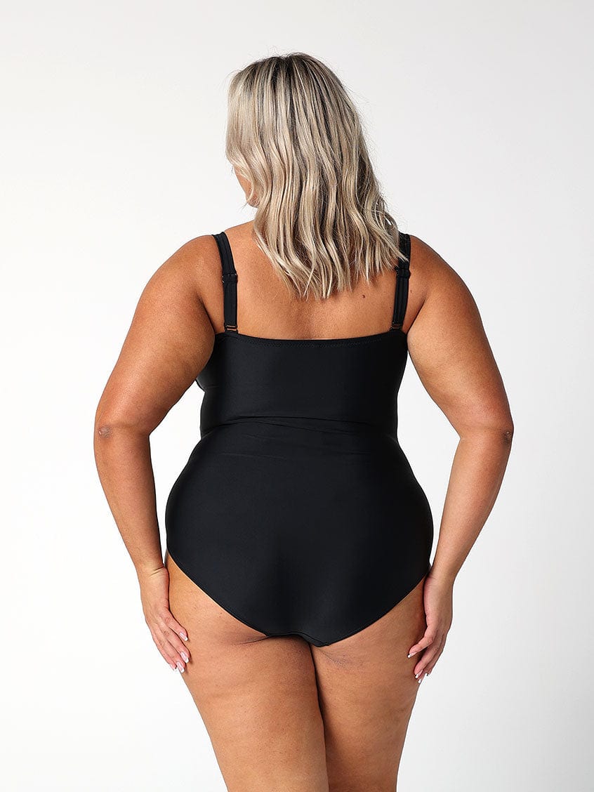 model showing back of full coverage black swimsuit