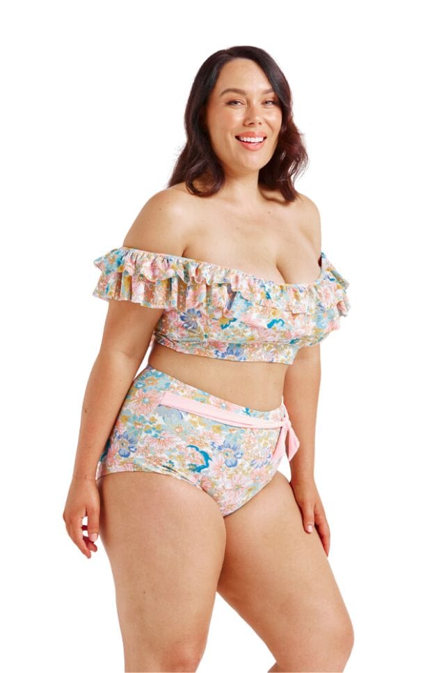 Curve model wearing double frilled bikini top in multi pastel colour floral print