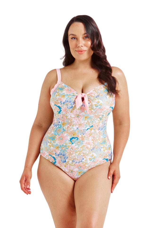 Brunette curve model wearing multi pastel coloured one piece with pink straps and tie front detail