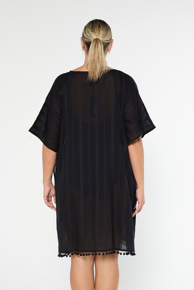 model showing back of black cotton kaftan with pom poms