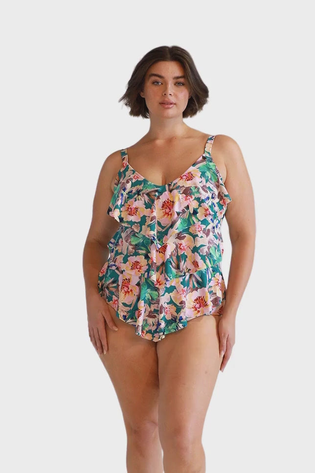 Curve model wearing high waisted flattering swim pant in teal floral print