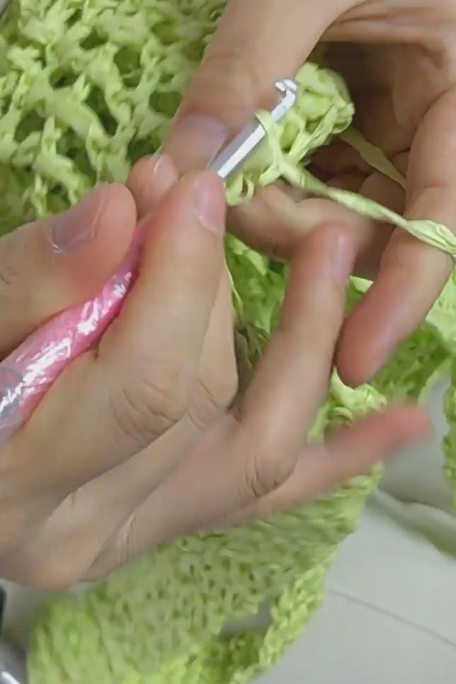 Video of person hand making crochet tote beach bag in citrus colour
