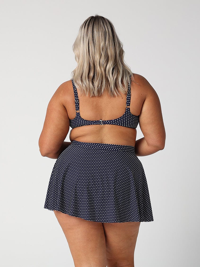 model showing back of navy retro dot swim skater skirt