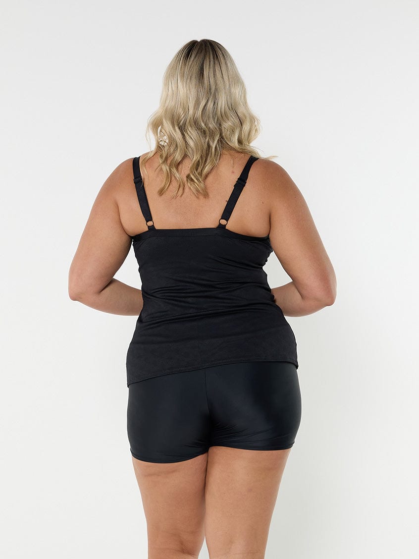 Blonde model showing back of black and white underwire tankini top