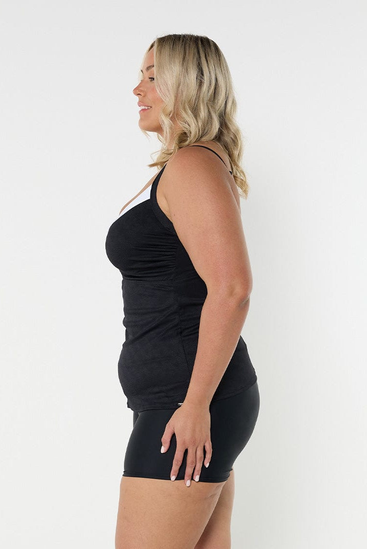 Blonde model wearing black and white underwire tankini top
