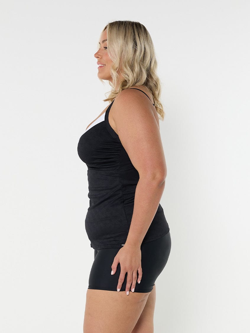 Blonde model wearing black and white underwire tankini top