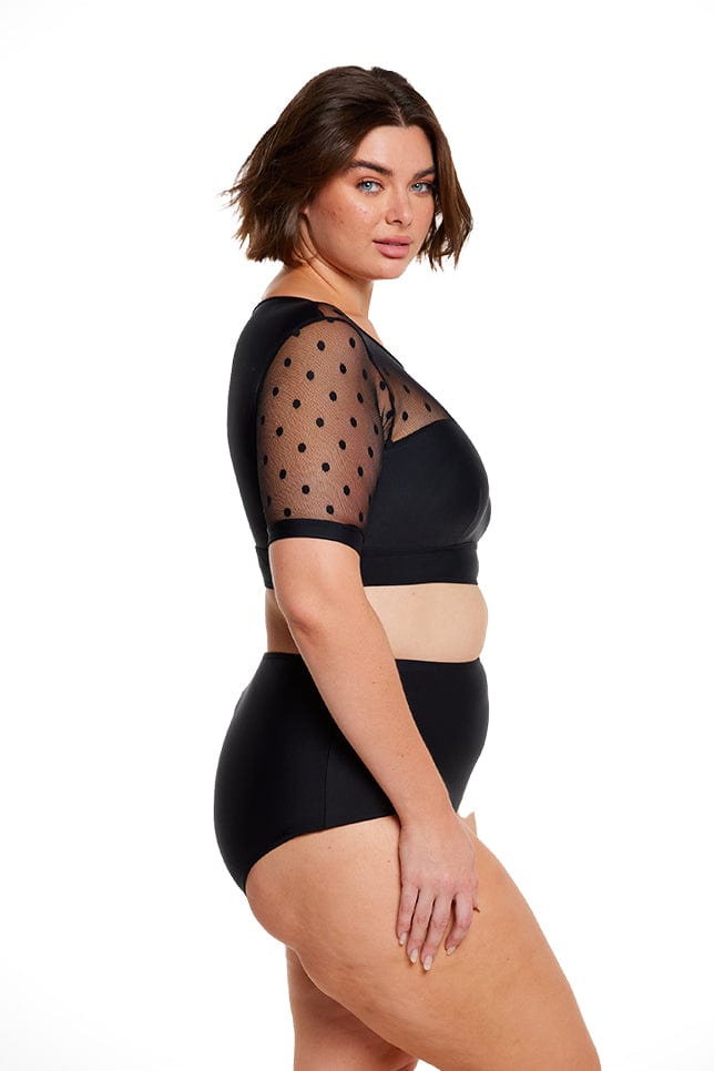Brunette women wears mesh polkadot short sleeve cropped bikini top