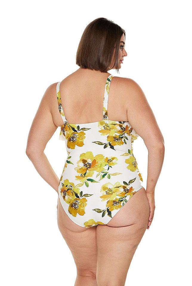 Brunette model wearing yellow model v neck ruffle swimsuit for curve model