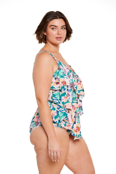 Brunette model wears loose fitting tankini top in green and pink floral print
