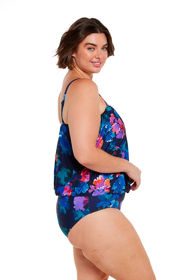 brunette size 16 model wears navy floral bandeau one piece with removable straps