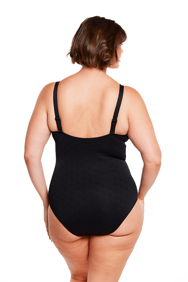 brunette model wears black supportive one piece swimwear australia