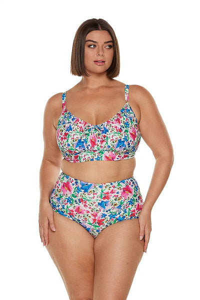 Brunette model wears bright floral underwire bikini top with adjustable straps and tie detail