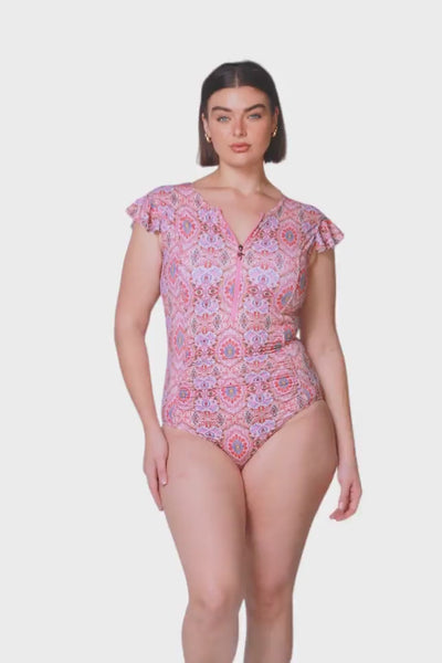 brunette model wearing pink mosaic frill sleeve one piece swimsuit