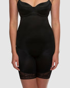 Black shapewear garment on a plain background