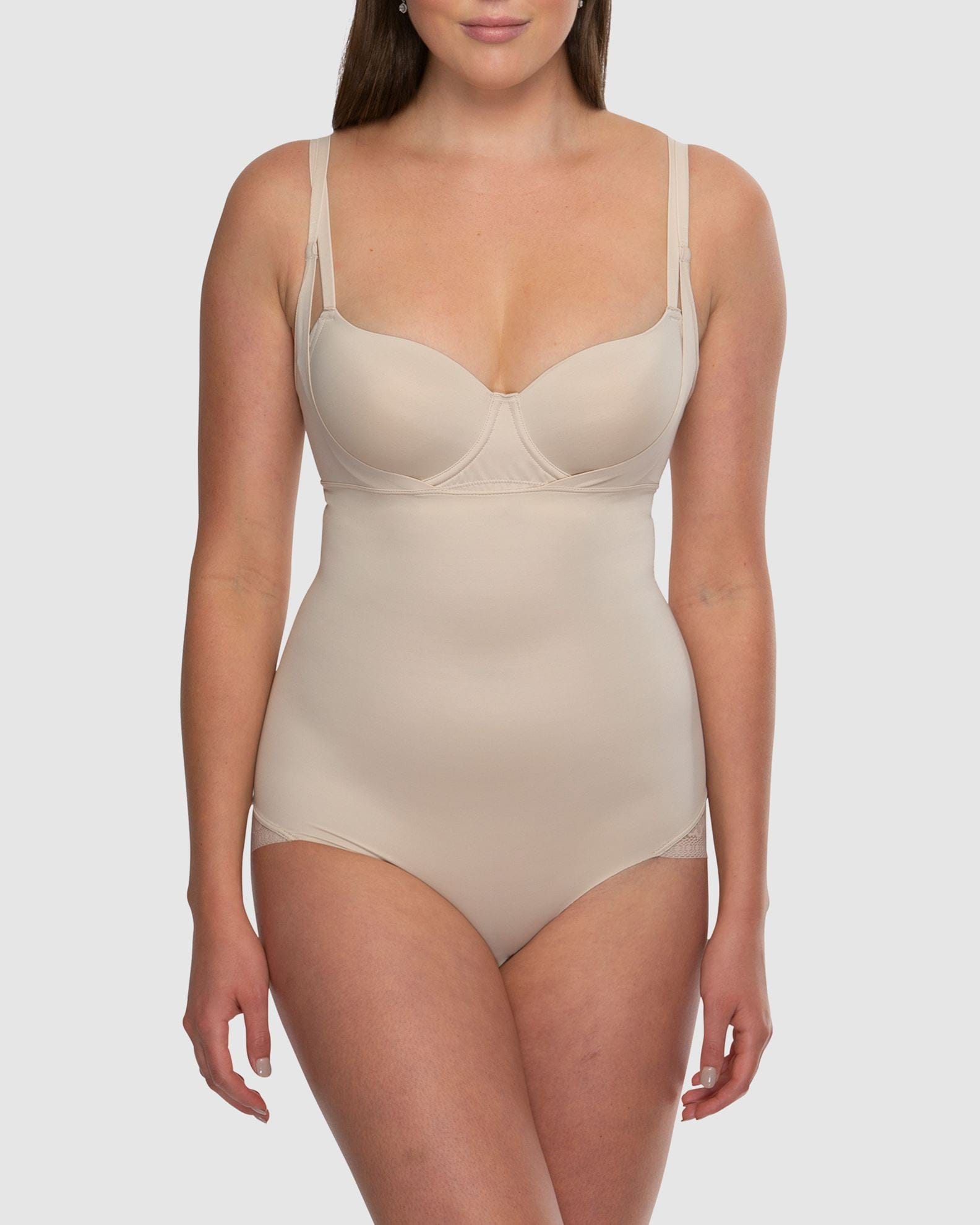 Beige shapewear bodysuit worn by a model on a white background