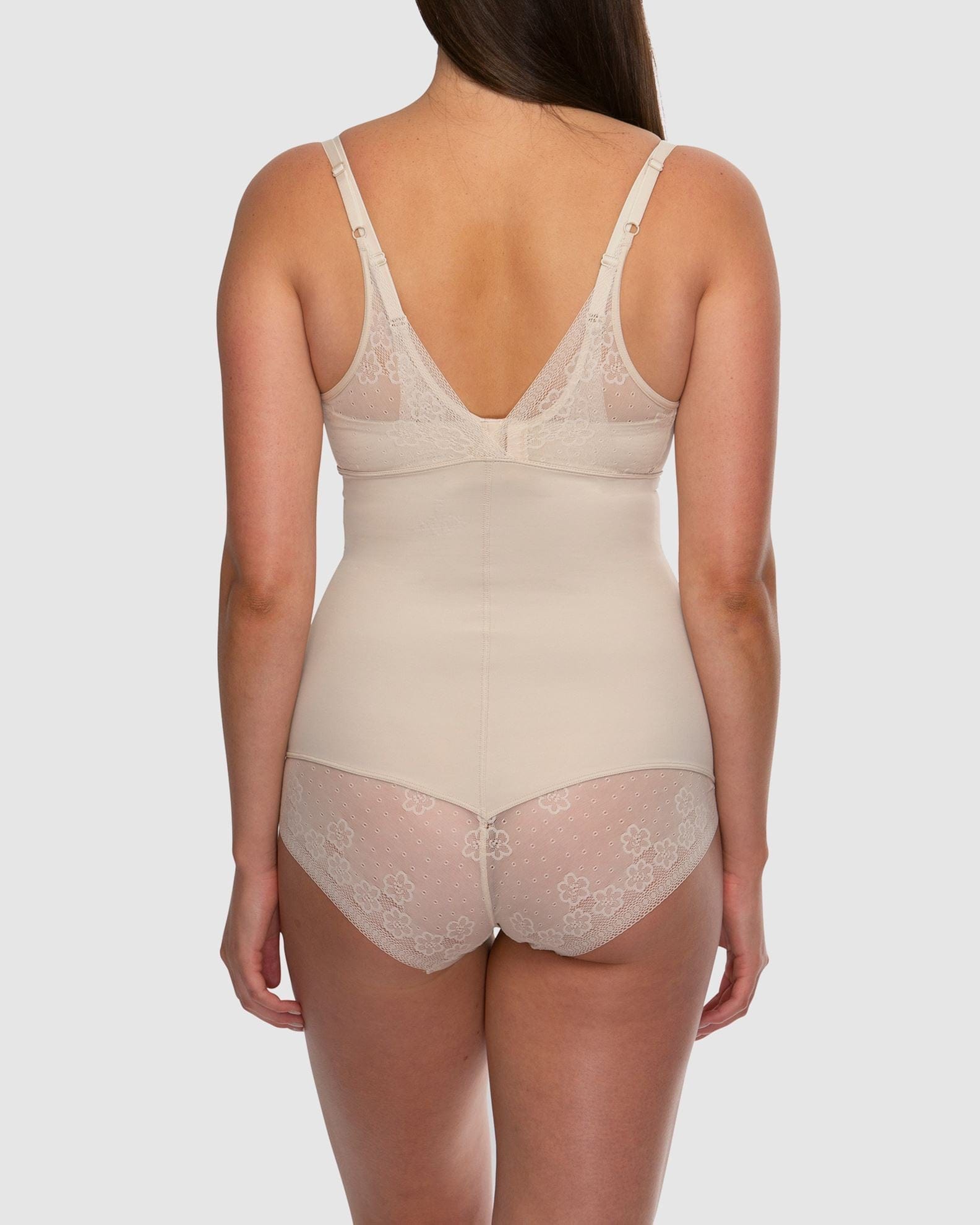 Beige bodysuit with lace details on a plain background