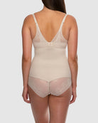 Beige bodysuit with lace details on a plain background
