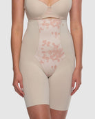 Beige shapewear with floral mesh panel on a plain background