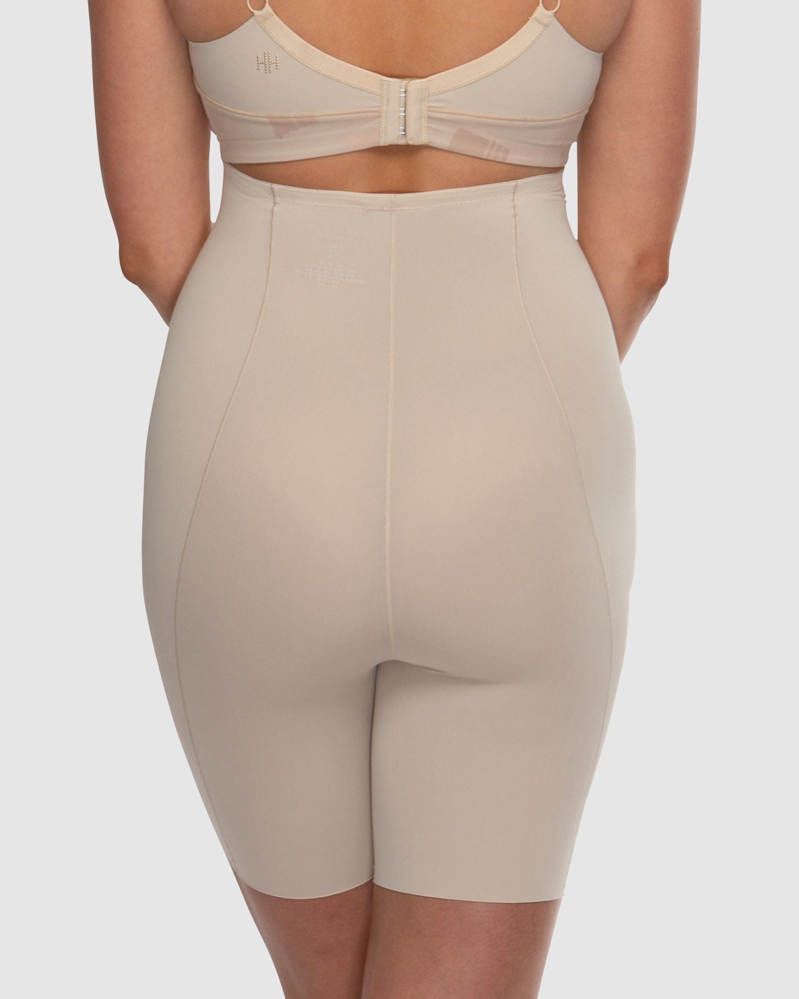 Beige shapewear worn by a person on a plain background