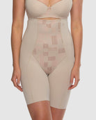 Beige shapewear garment worn by a model on a plain background
